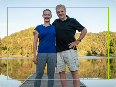 man and woman standing happily on a dock by the water